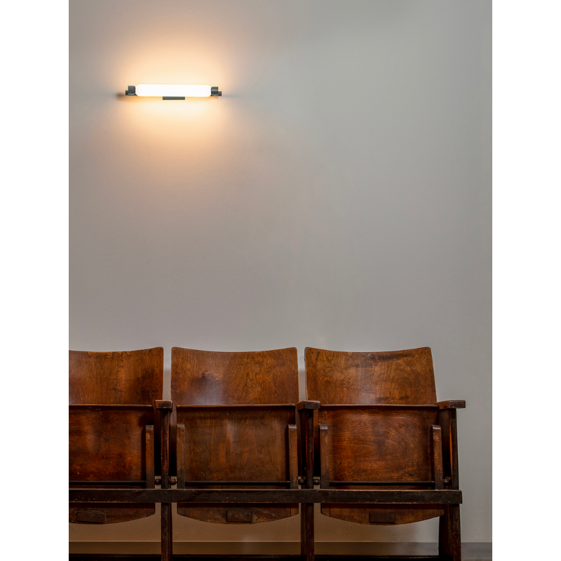 The La Roche Wall Sconce from Nemo in gray in a business space.