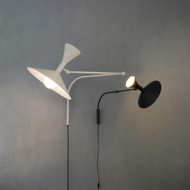 The Lampe de Marseille Mini Wall Sconce from Nemo in black within a living area.