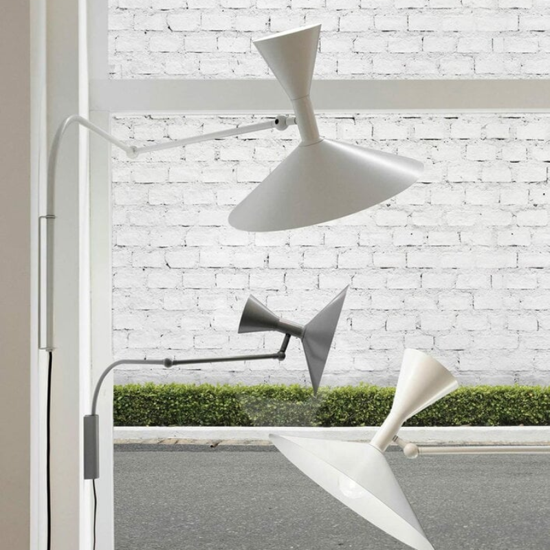 The Lampe de Marseille Mini Wall Sconce from Nemo in whitewash in a living area.