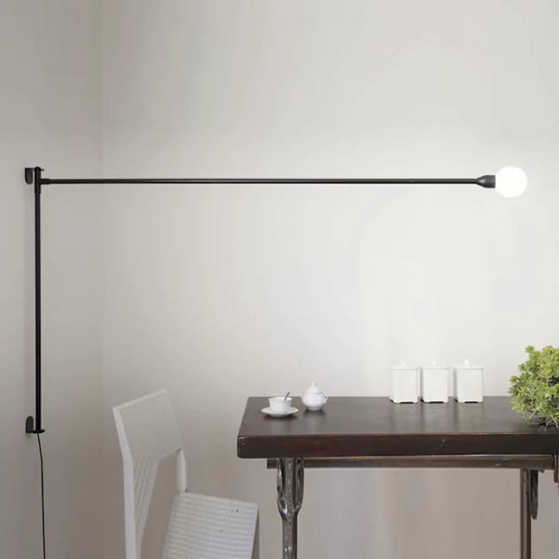 The Potence Pivotante Wall Sconce from Nemo in a dining room.