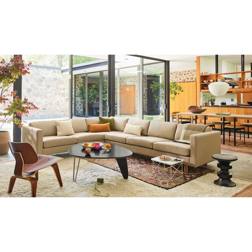 The Noguchi Rudder Coffee Table from Herman Miller in Black Ebony Maple in a mid-century modern living room.