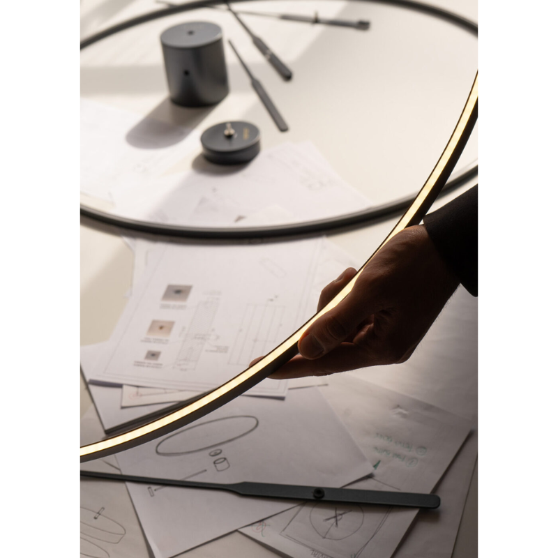 The Ombra Clock from Nomon in a photograph of the designer making the clock. all-groups