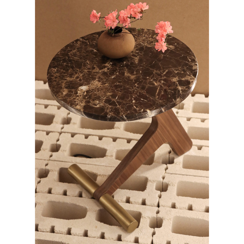 The emperador marble with walnut Puntero Side Table from Nomon in a living room.