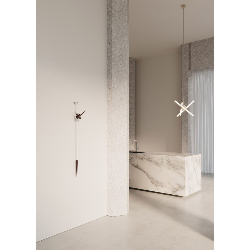 The graphite steel and walnut Punto y Coma Clock from Nomon in a family space.