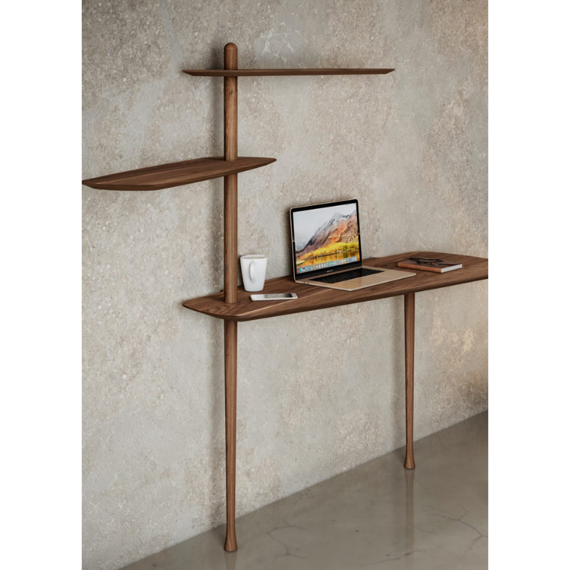 The walnut Unica Escritorio Desk from Nomon in a living room.