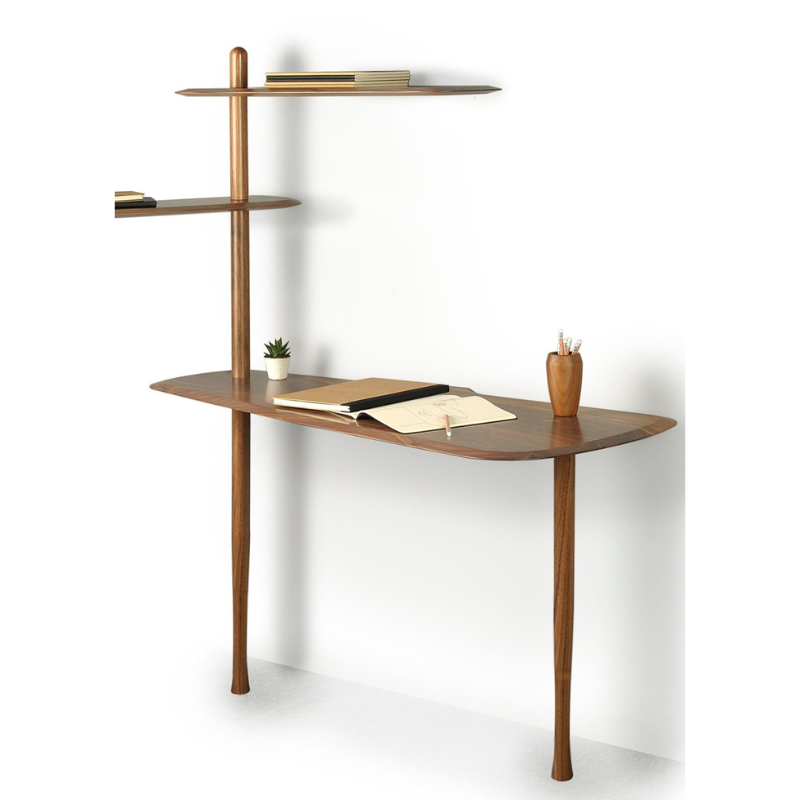 The walnut Unica Escritorio Desk from Nomon in a studio.