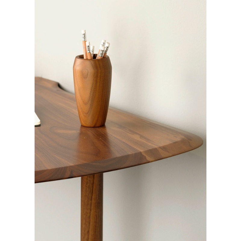 The walnut Unica Escritorio Desk from Nomon in a workspace.