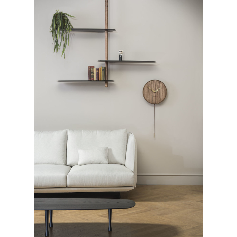 The black ash Unica Shelving Ceiling from Nomon used as a bookshelf.