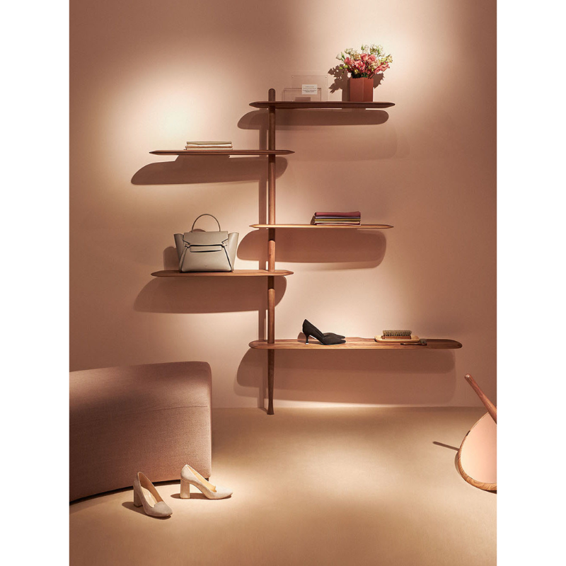 The walnut Unica Shelving Floor from Nomon in a living room.