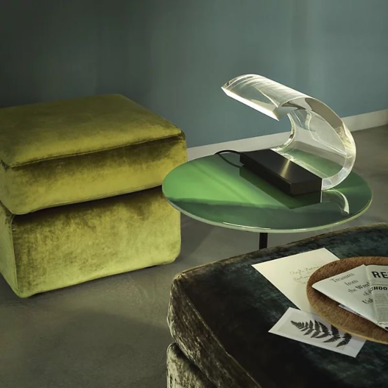 The Acrilica Table Lamp from Oluce in a primary bedroom.