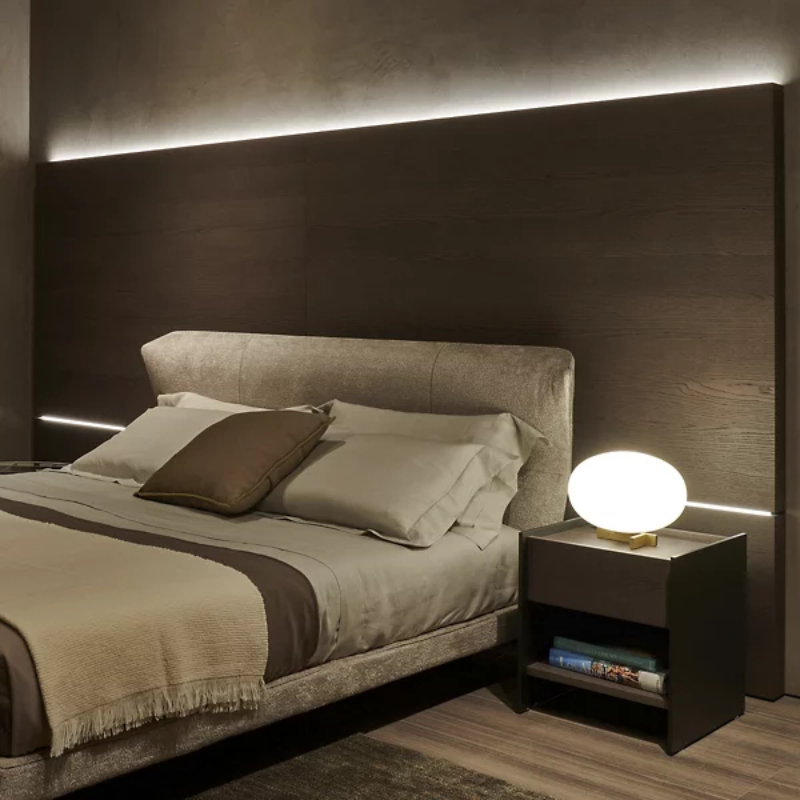 The Alba Table Lamp from Oluce in a bedroom.