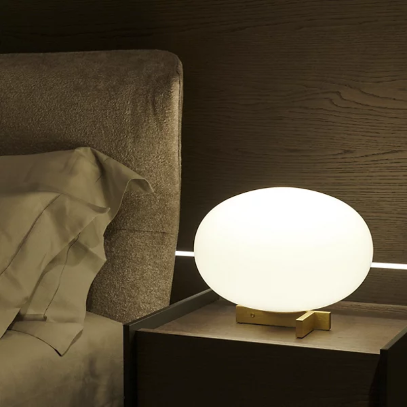 The Alba Table Lamp from Oluce on a bedside table.