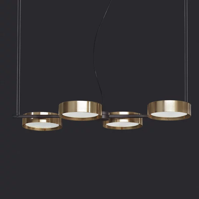 The Berlin Linear Suspension from Oluce in matte black with anodized brass in a studio.
