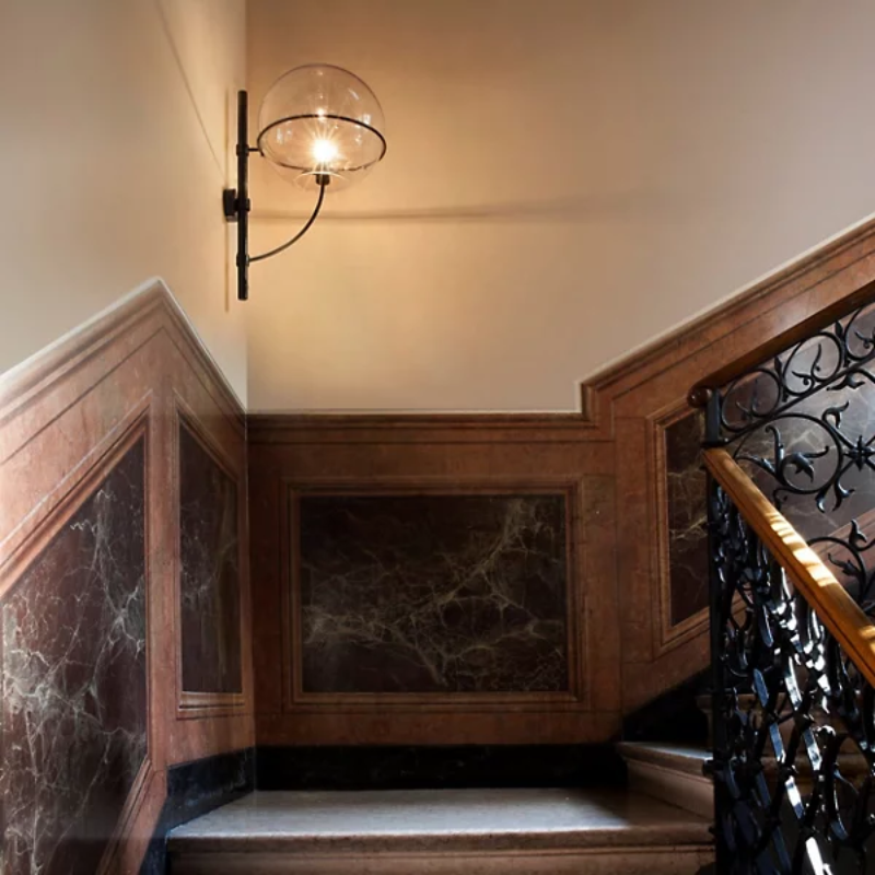 The Lyndon Outdoor Wall Sconce from Oluce in a hallway.