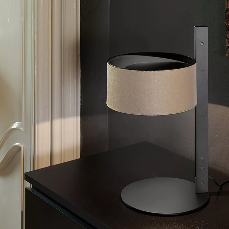 The Parallel Table Lamp from Oluce in sand leather in a living room.