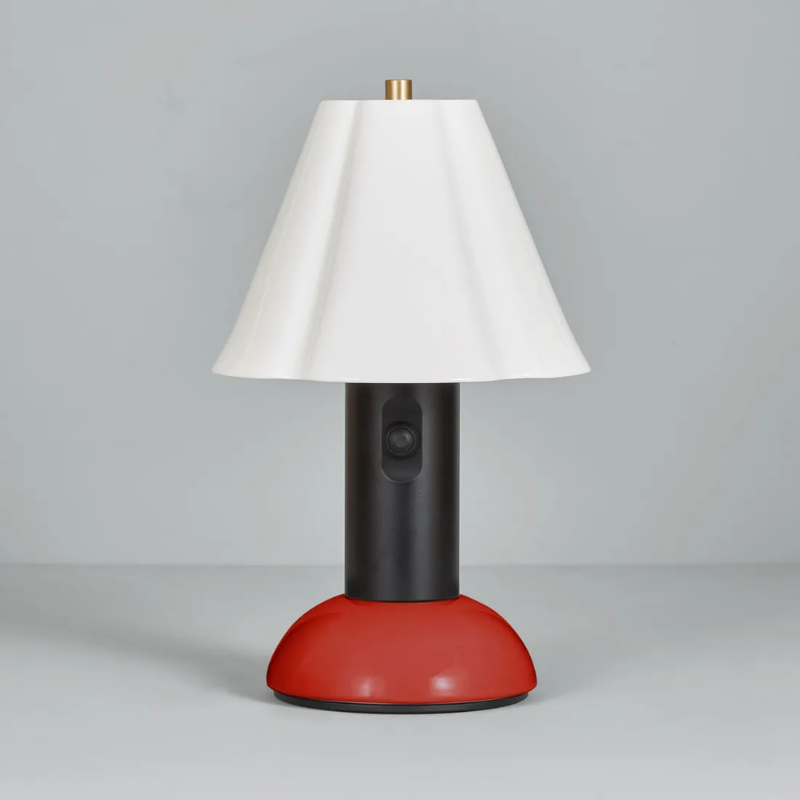 The Blossom Portable Light from Original BTC in rusty red in a studio.