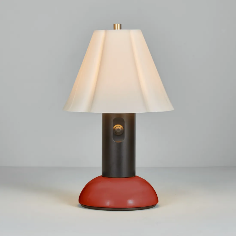 The Blossom Portable Light from Original BTC in rusty red turned on.
