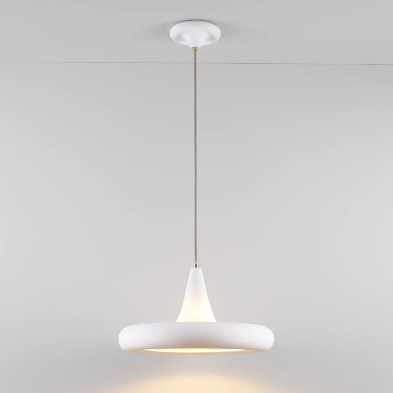 The Drop Three Pendant from Original BTC turned on in a living room.