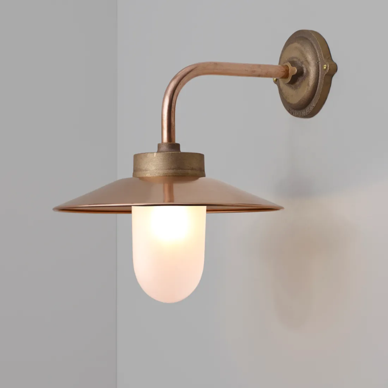 The Exterior Bracket Light from Original BTC in bronze with a frosted glass diffuser in a lounge.