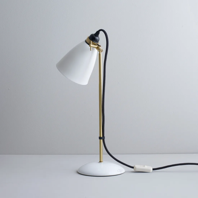 The Hector 30 Table Light from Original BTC with a black cable in a studio from an angle.