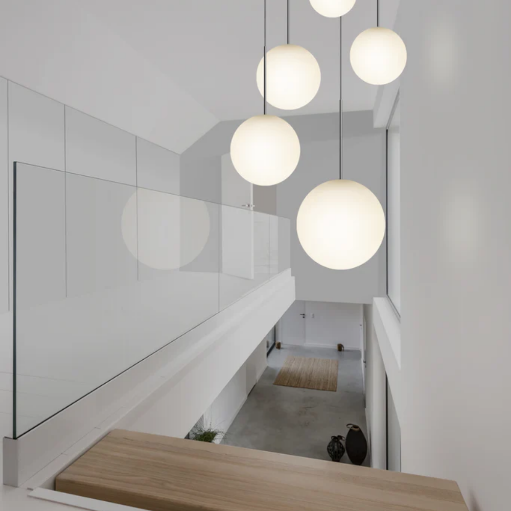 The Bola Sphere from Pablo Designs in a hallway above a staircase. all-groups