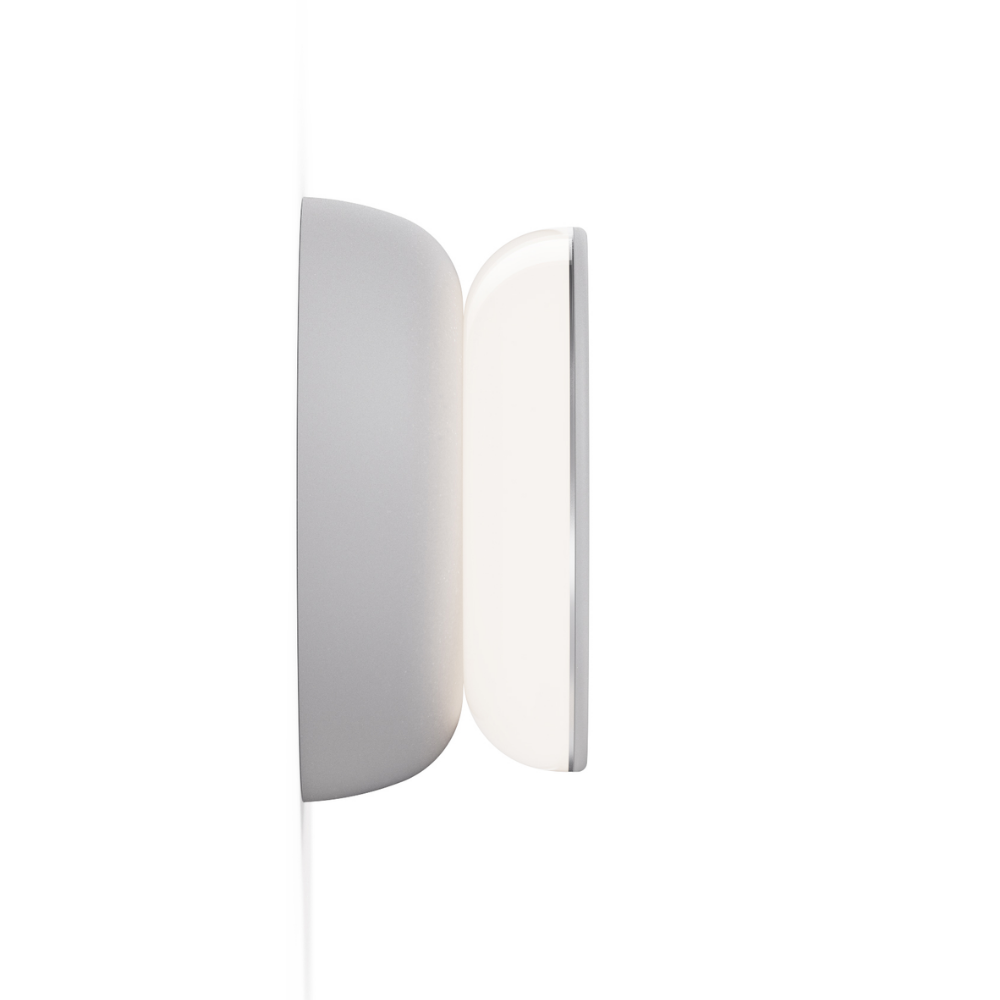 The side of the grey and grey Totem Puck Ceiling or Wall Light from Pablo Designs in a profile view.