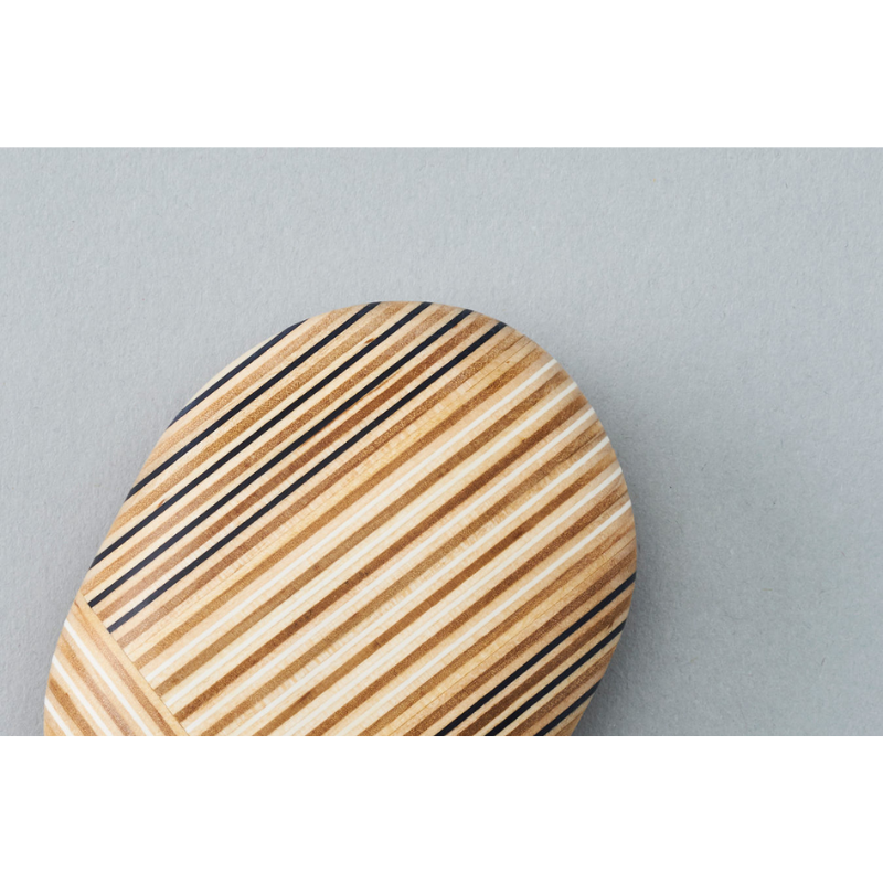 The Koishi Paperweight from Plywood Laboratory ellipse shape in navy close up.