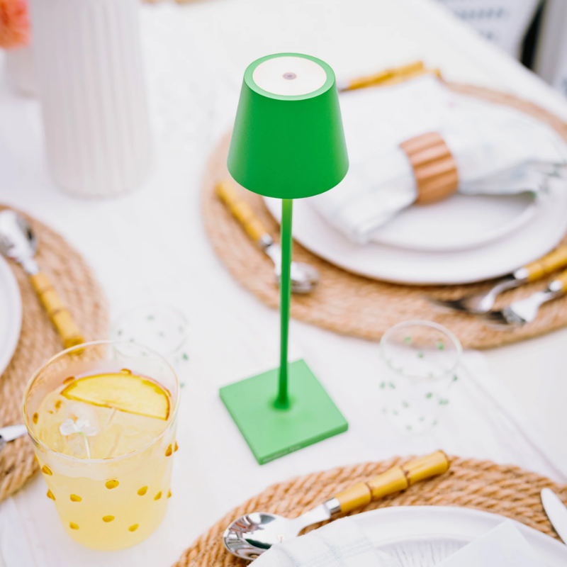 The apple green Poldina Pro Micro from Zafferano on an outdoor dining table.