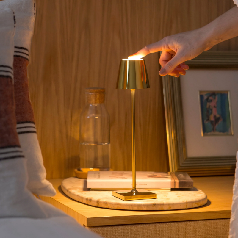 The glossy gold Poldina Pro Micro from Zafferano in a living space.