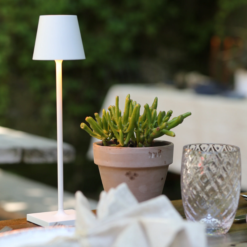 The white Poldina Pro Micro from Zafferano in an outdoor lounge.