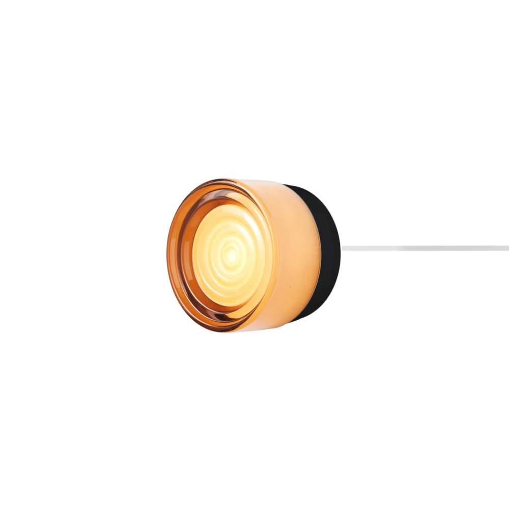 The Ripple Corded Sconce with plug-in back in copper exterior shade with black anodized.