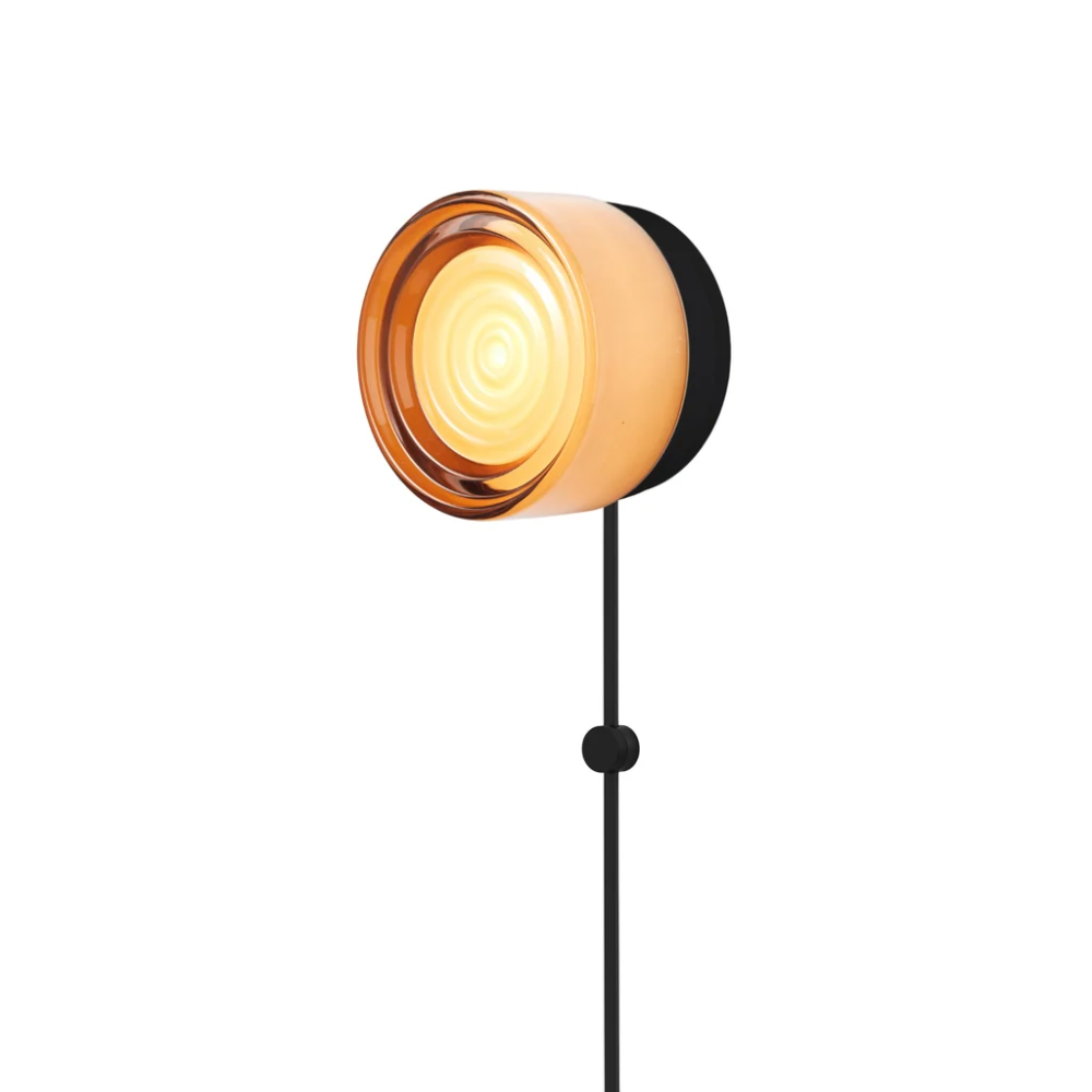 The Ripple Corded Sconce with plug-in bottom in copper exterior shade with black anodized.
