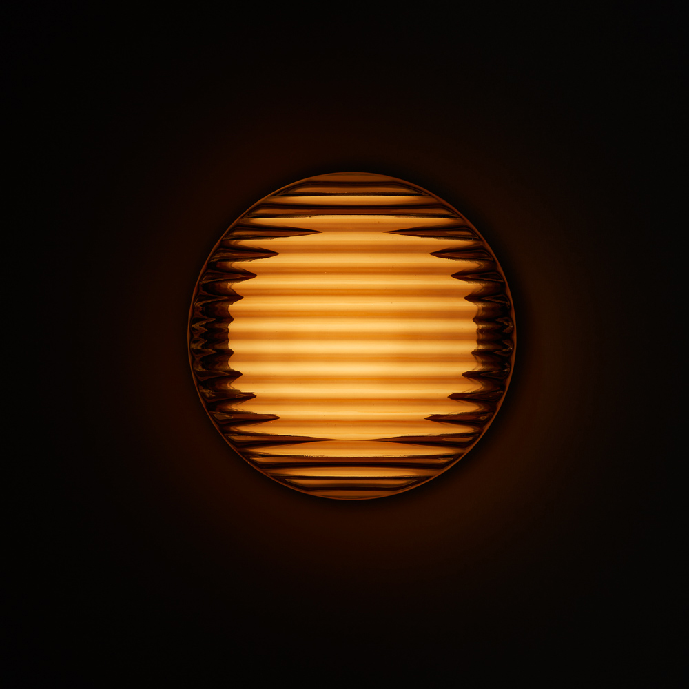 A Copper Crisp Sconce by RBW illuminated in the dark. all-groups
