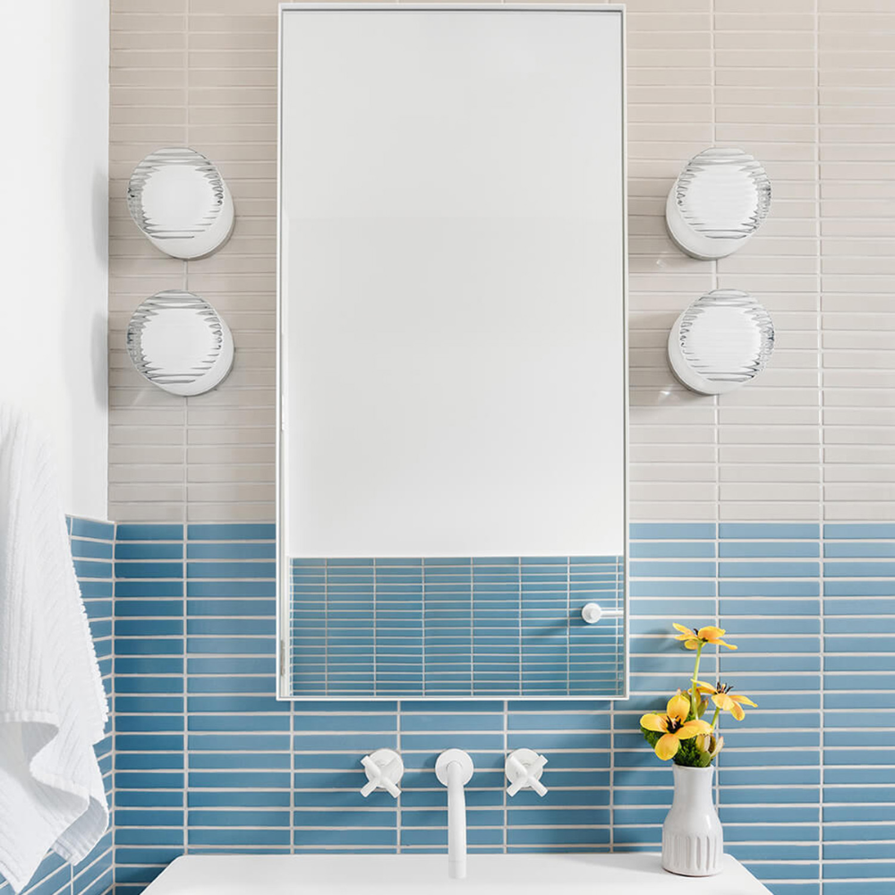 Two pairs of Crisp Sconces by RBW installed on either side of a mirror. all-groups