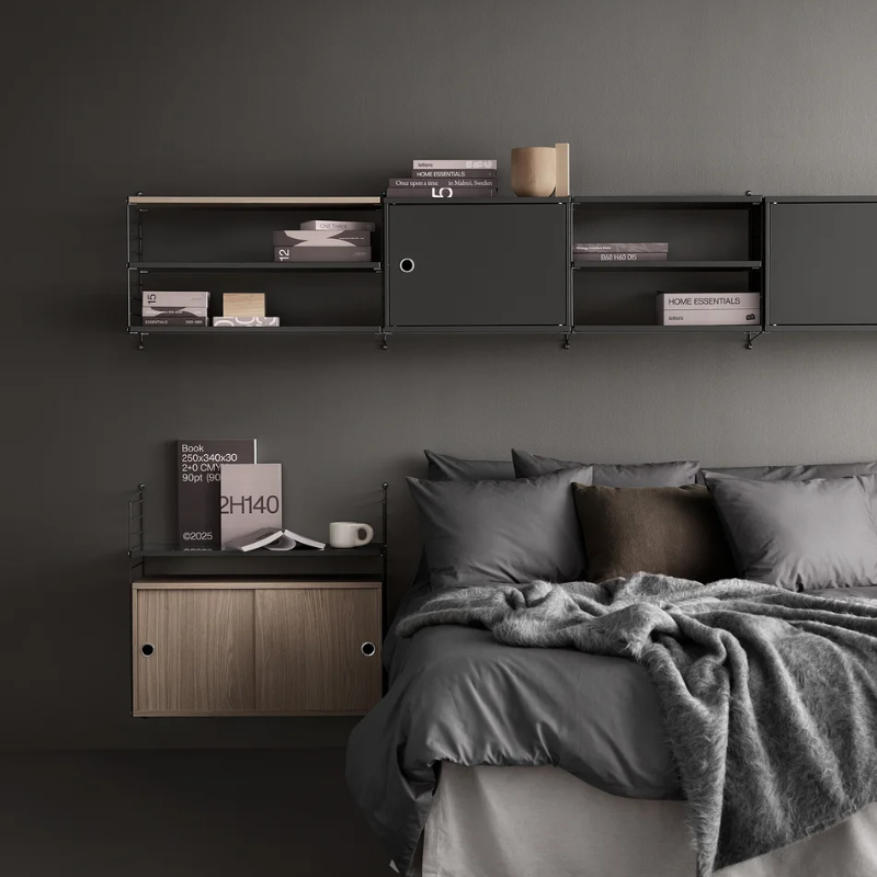 The Cabinet with Swing Door from String Furniture in dark grey in a primary bedroom.