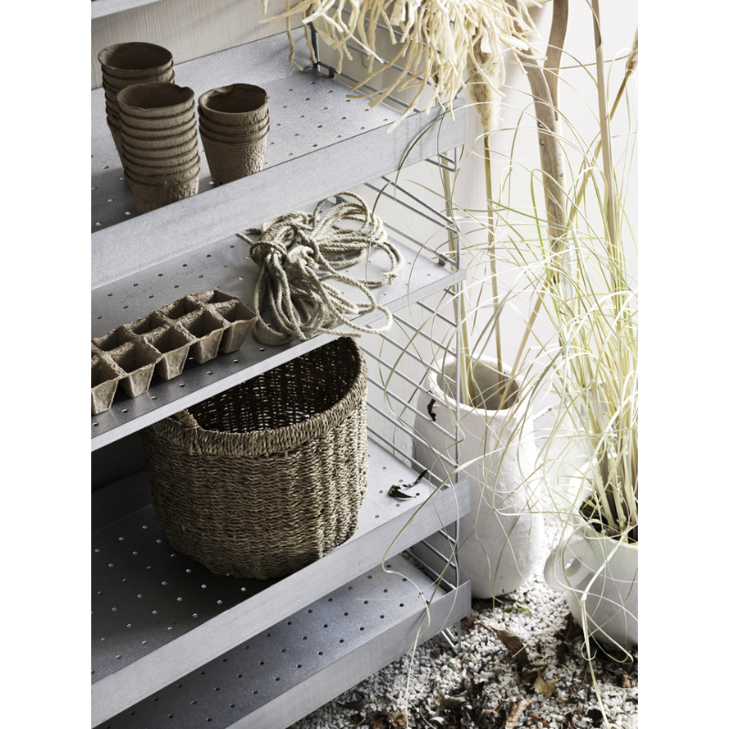 The Galvanized Floor Panels from String Furniture in an outdoor lounge lifestyle photograph.