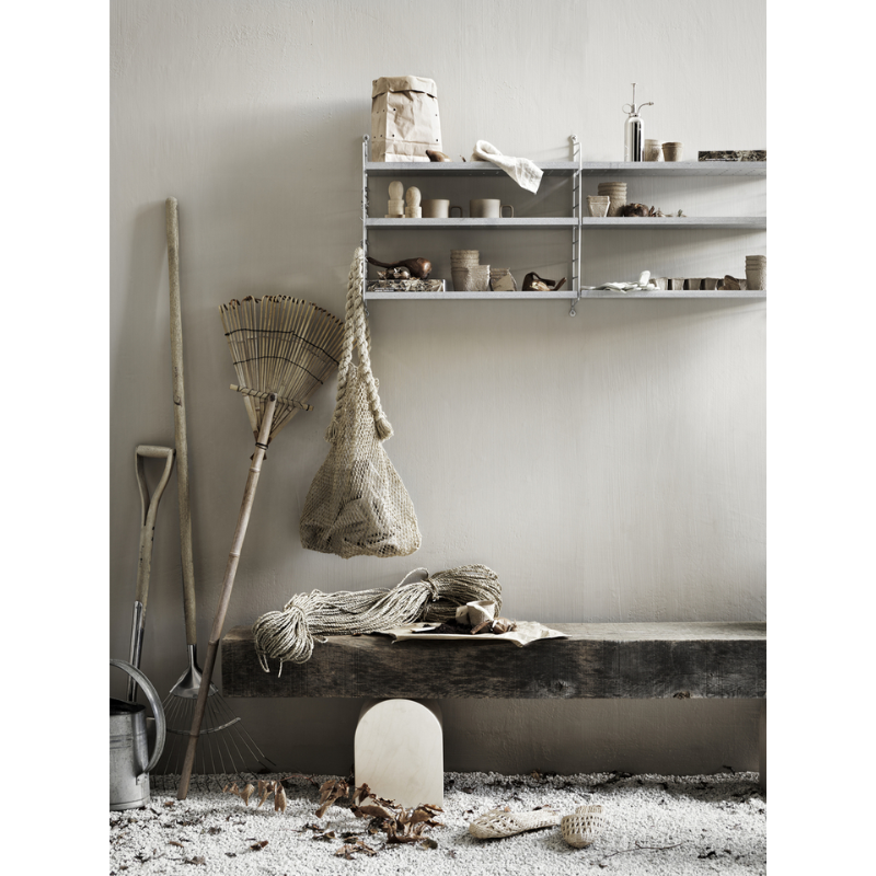 The Galvanized Shelf from String Furniture in a living area.