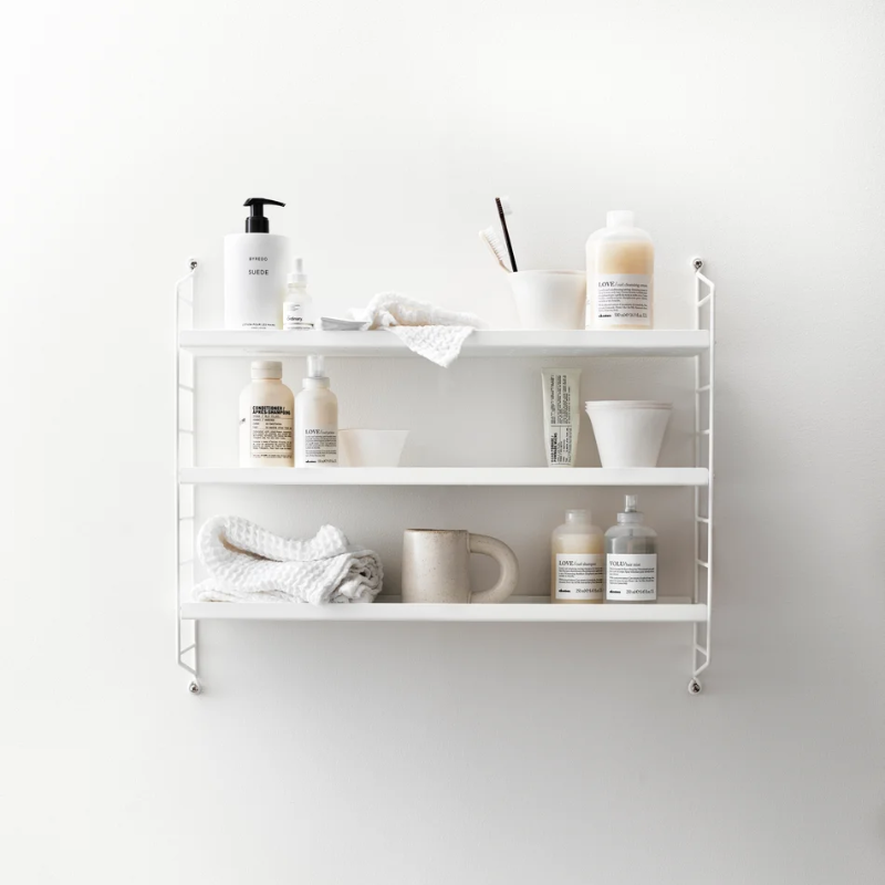 The Metal String Pocket from String Furniture in white in a living room.