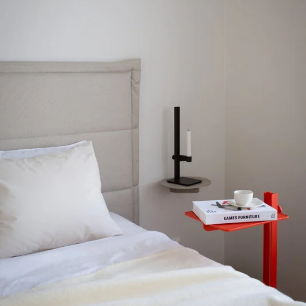 The Museum NM&.045 Console Shelf from String Furniture in beige installed next to a bed.