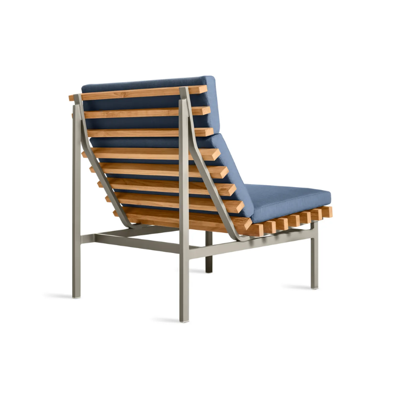 The Perch Outdoor Lounge Chair from Blu Dot with carbon frame and sunbrella haze upholstery from the back at an angle.