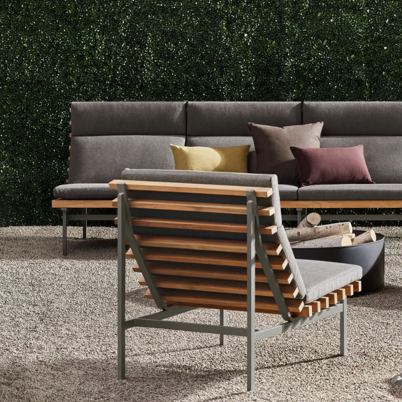 The Perch Outdoor Lounge Chair from Blu Dot with carbon frame and toohey charcoal upholstery in an outdoor lounge.