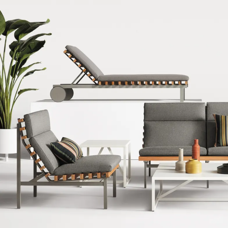 The Perch Outdoor Lounge Chair from Blu Dot with carbon frame and toohey charcoal upholstery in a studio.