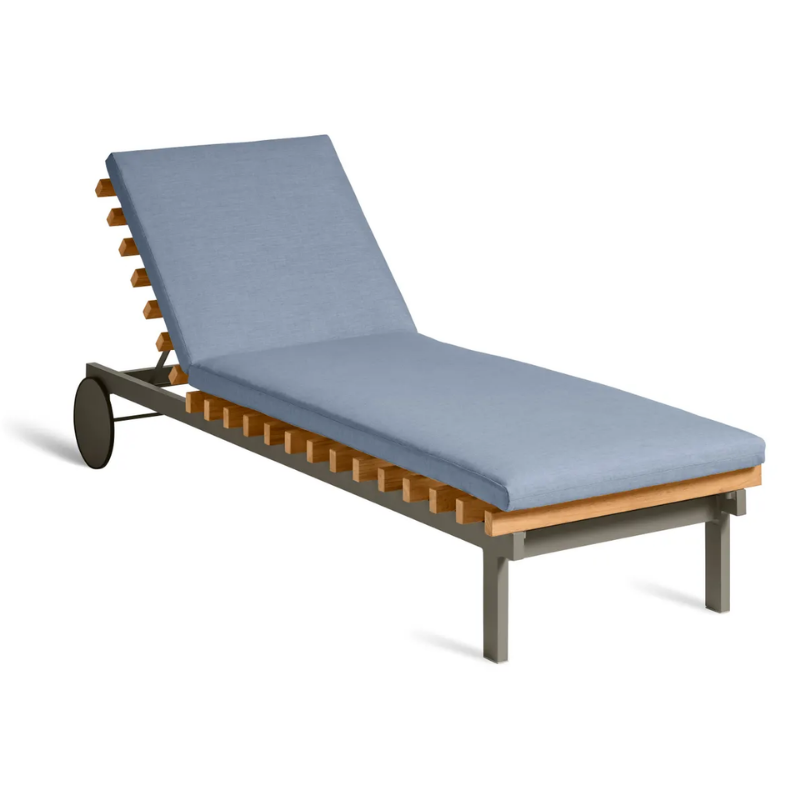 The Perch Outdoor Sun Lounger from Blu Dot with the carbon frame and sunbrella haze upholstery from an angle.