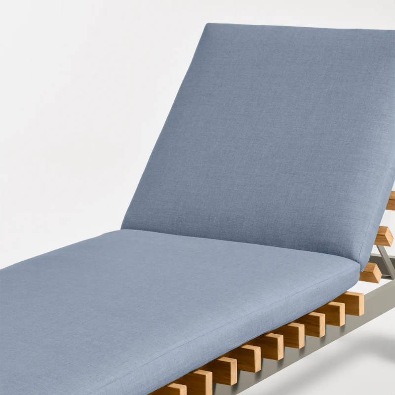 The Perch Outdoor Sun Lounger from Blu Dot with the carbon frame and sunbrella haze upholstery in a close up.