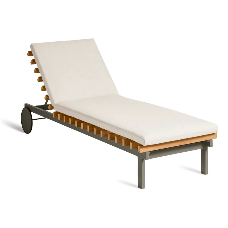 The Perch Outdoor Sun Lounger from Blu Dot with the carbon frame and sunbrella linen upholstery from an angle.