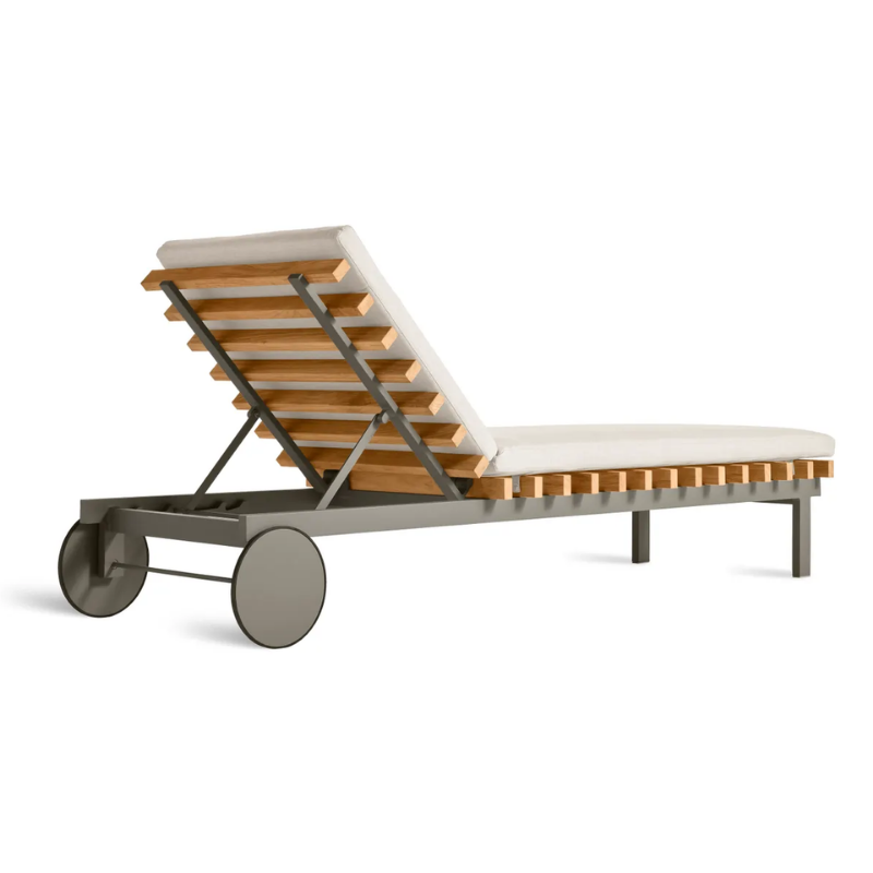 The Perch Outdoor Sun Lounger from Blu Dot with the carbon frame and sunbrella linen upholstery from the back at an angle.