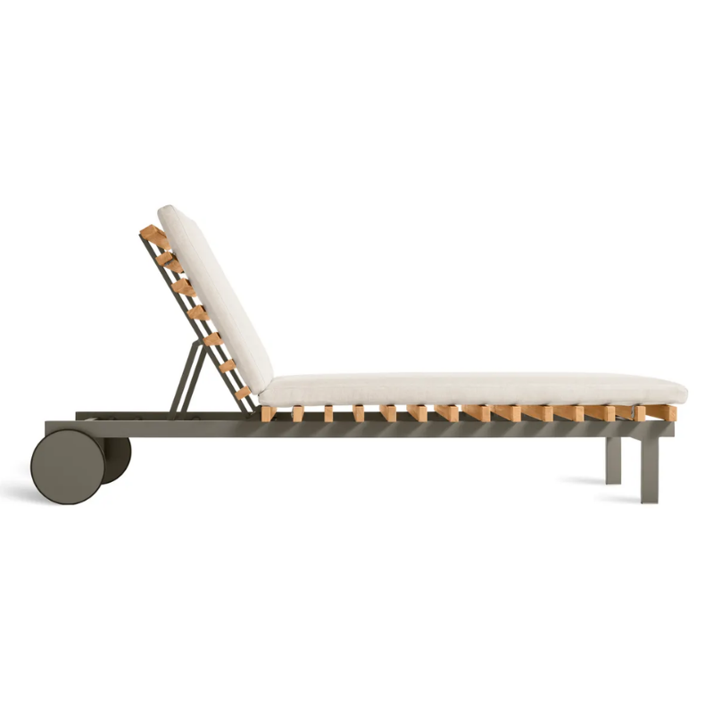 The Perch Outdoor Sun Lounger from Blu Dot with the carbon frame and sunbrella linen upholstery from the side.