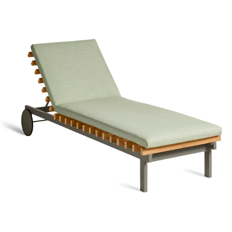 The Perch Outdoor Sun Lounger from Blu Dot with the carbon frame and sunbrella oasis upholstery from an angle.