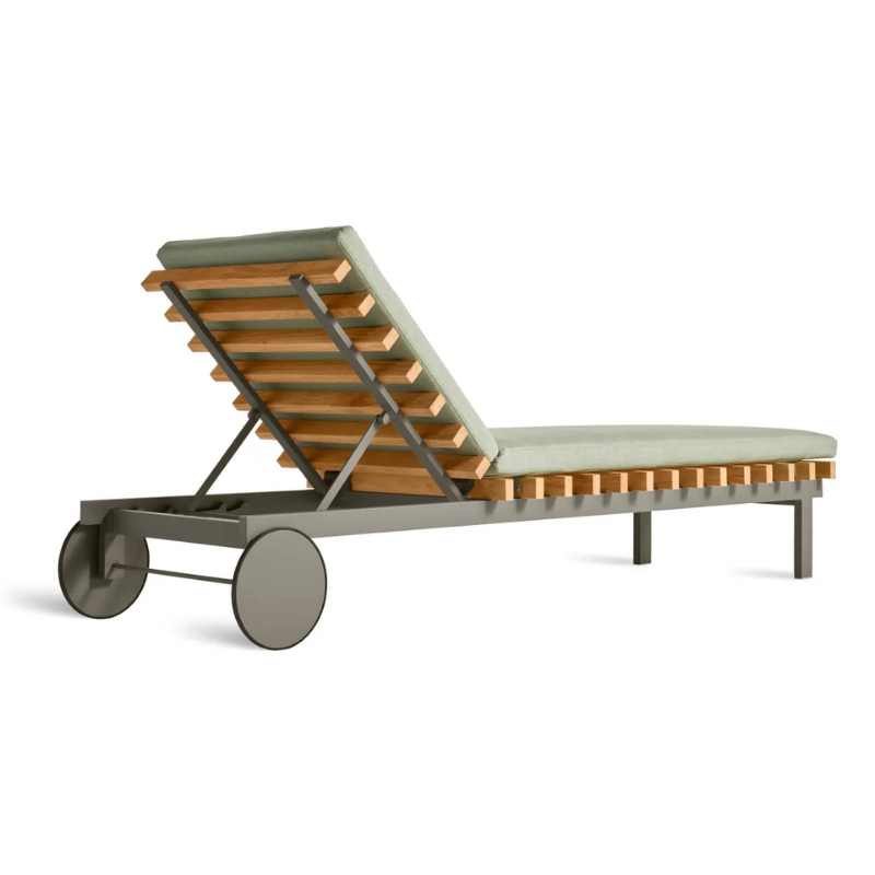 The Perch Outdoor Sun Lounger from Blu Dot with the carbon frame and sunbrella oasis upholstery from the back at an angle.