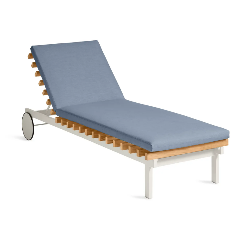 The Perch Outdoor Sun Lounger from Blu Dot with the white frame and sunbrella haze upholstery from an angle.
